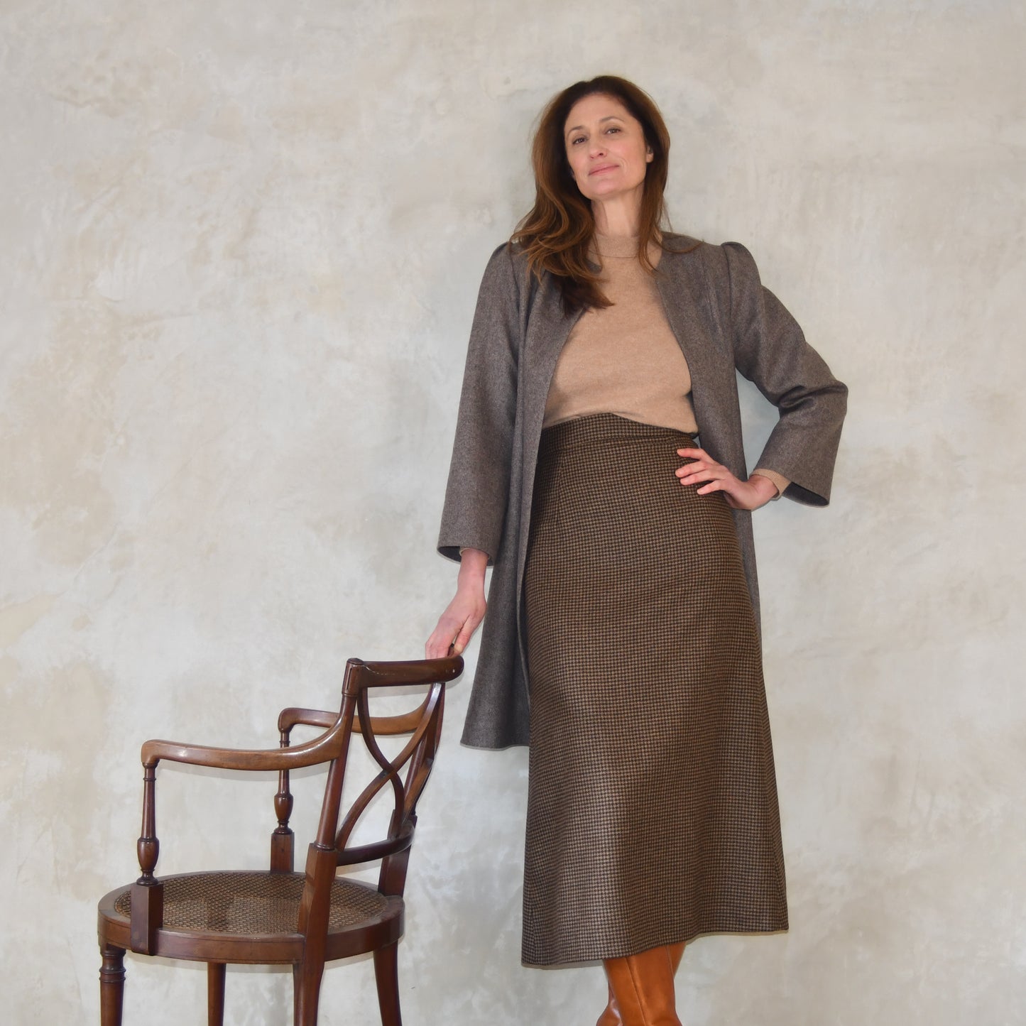 Bespoke Shoulder Detail Trapeze Coat in Fawn Merino Flannel. An elegant alternative to a jacket, our mid length trapeze coat will take you to town and country and back. Standing view.