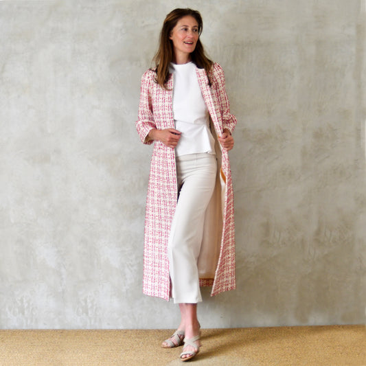 Bell Sleeve A-Line Coat in Pink Patterned Linton Tweeds Boucle. A pretty, longer length A-line coat in a pink, cream and gold check pattern for smart spring and summer occasions. Entirely made in Great Britain.