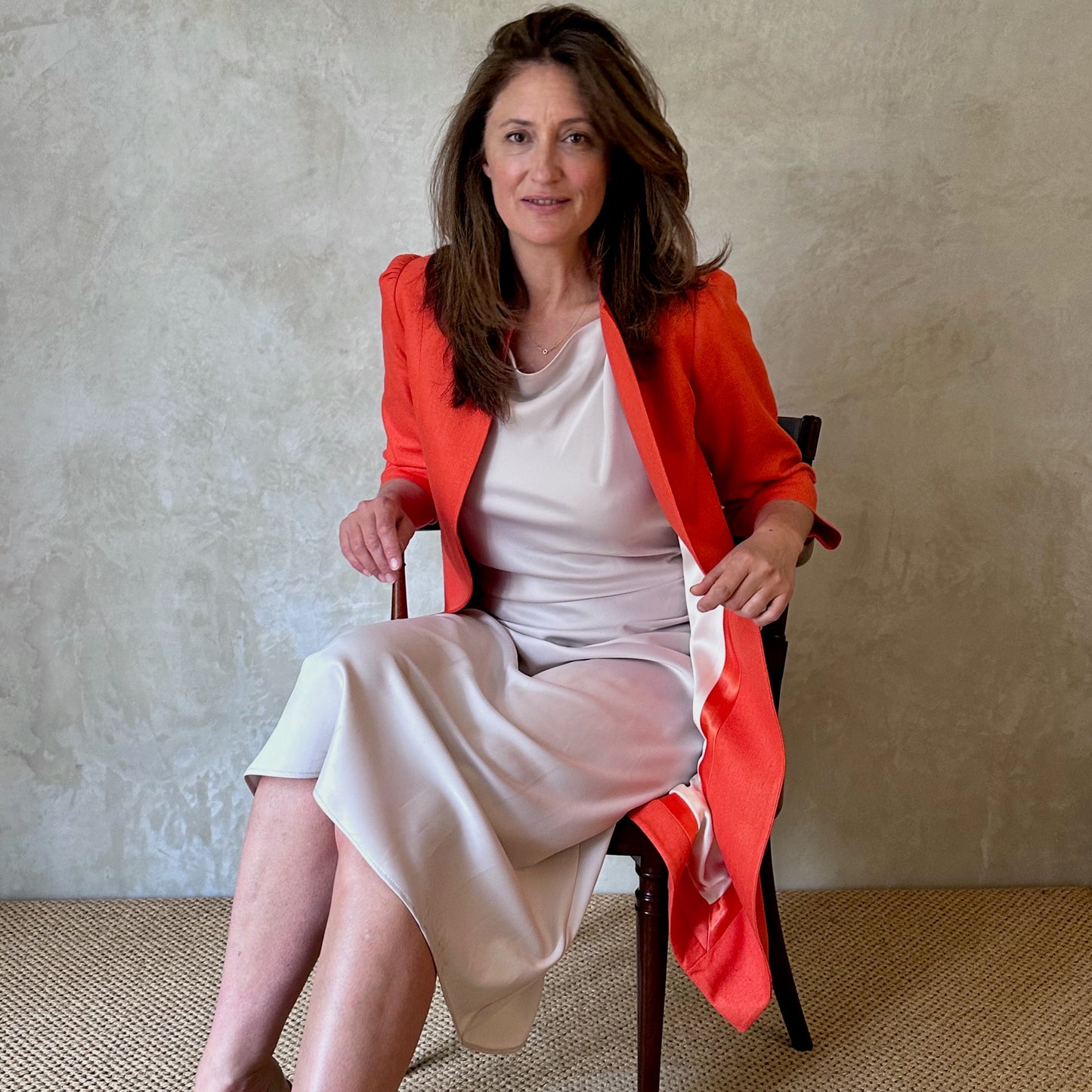 Bespoke Shoulder Detail Trapeze Coat in Silk Matka. This is a Summer Weight Silk Car Coat style shorter length coat available to order in a host of colours. Handmade in Great Britain. Seated view.
