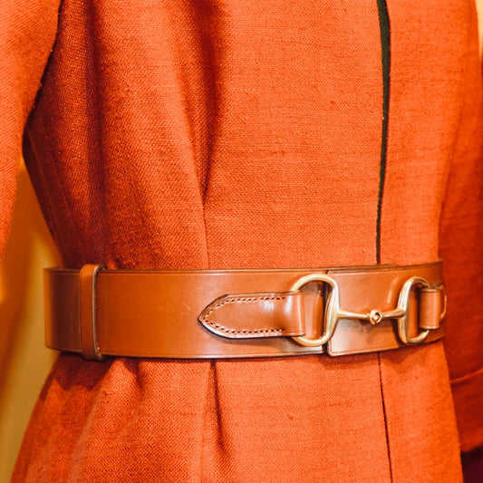 Orange silk dress with the EDNERAT Hazel Adjustable Bit Belt 95-110 cm, featuring solid brass fittings and decorative metal detail at the center. Handmade in Britain.