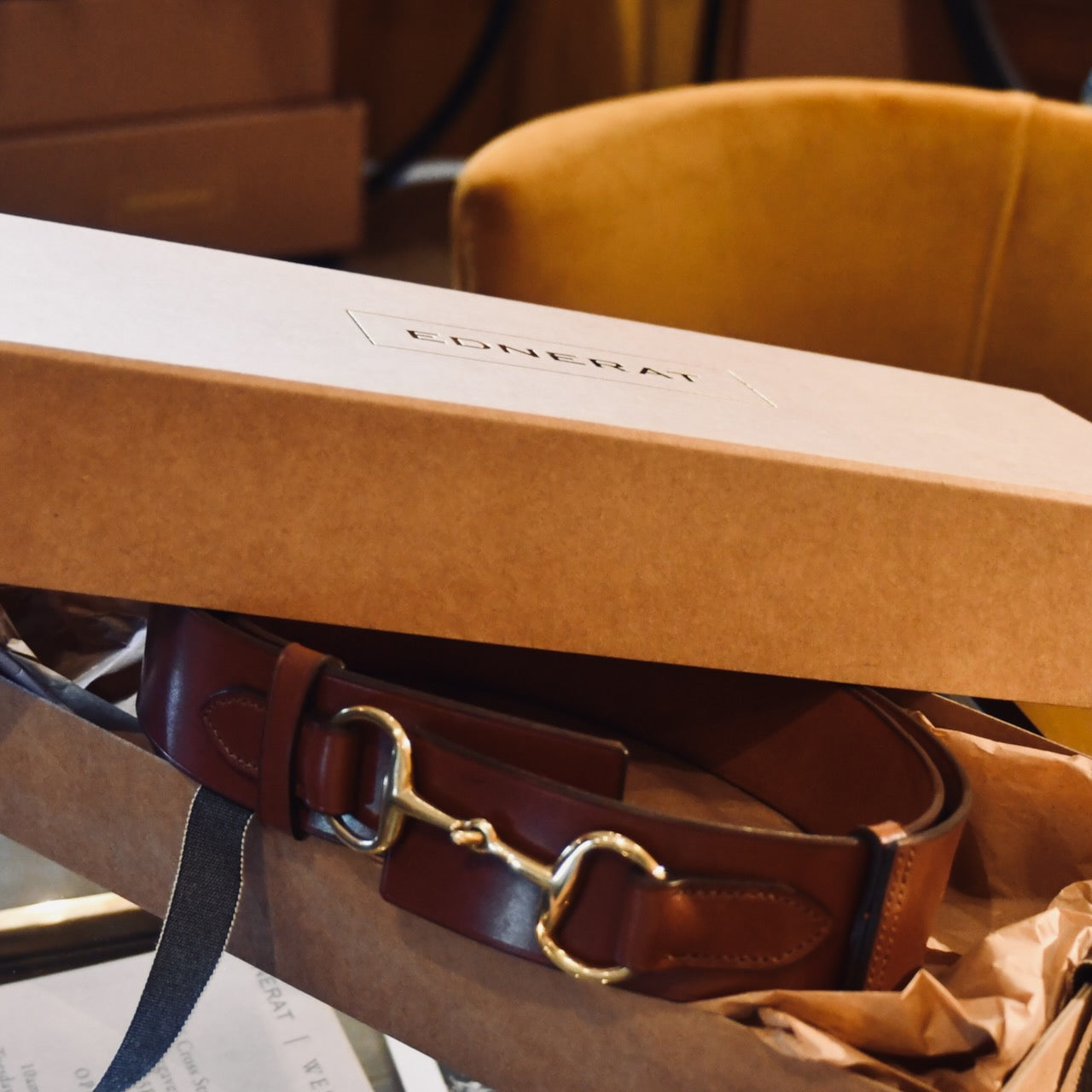 A Boxed saddle Leather Belt. The EDNERAT Hazel Adjustable Bit Belt 95-110 cm with brass buckle inside a Kraft Ednerat box. Handmade in Britain.