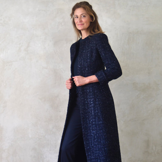 Tailored and Fitted Hourglass Coat in Dark Navy Boucle from Linton Tweeds. This investment piece has long sleeves and hidden pockets. Handmade in Britain. Side View