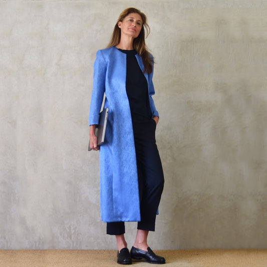 Bespoke Longer Length Hourglass shaped tailored coat in Silk Wool Mix Brocade—a tailored light blue coat. Handmade in Britain.