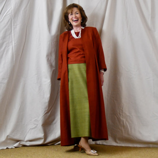 Fitted Occasion Coat in Summer Weight Silk Matka. A terracotta-coloured woven silk, falls gracefully from two front and rear dart details. Handmade in Britain.