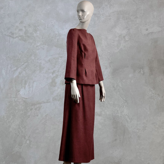 A Tailored Boat Neck Skirt Suit in Damson Silk Matka, featuring a fitted long-sleeve top and matching skirt. Handmade in Britain. Side View.