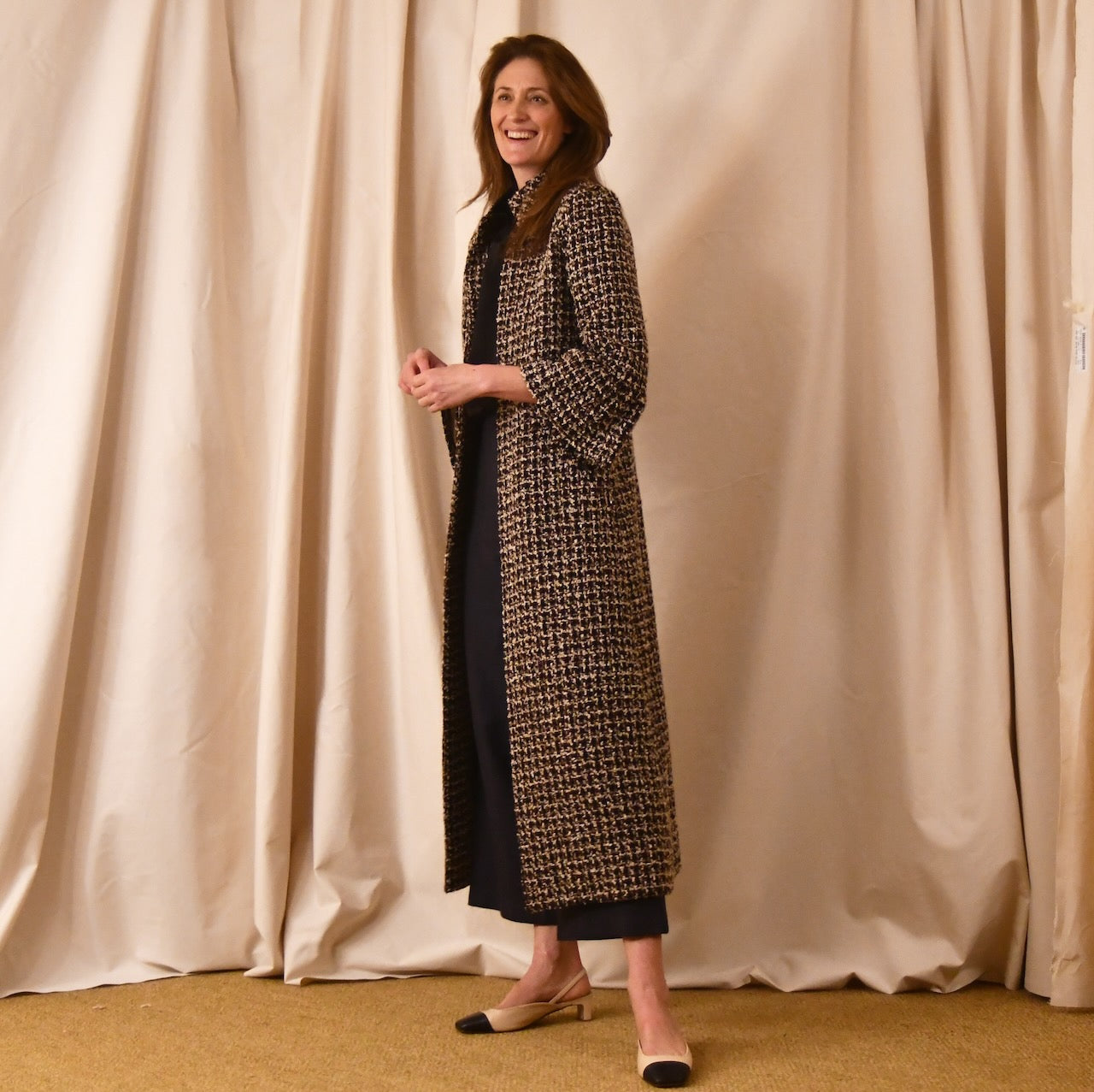 Bespoke Chanel-Style Bell Sleeve A-Line Coat in Check Linton Tweeds Boucle. Longer length ivory check boucle coat with frill cuff detail on sleeve – the perfect coat for evening wear and smart occasions. Made in Britain.