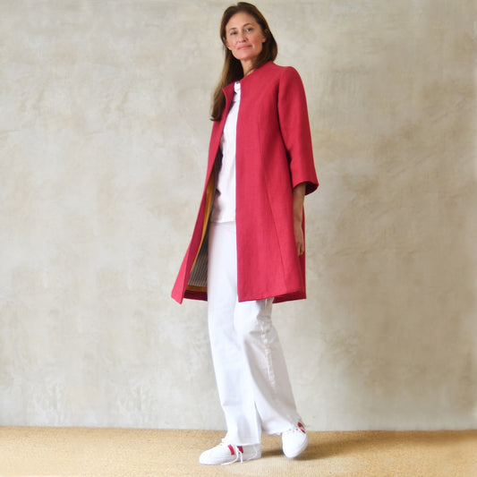 Trapeze Swing Coat in Deep Red Heavier Weight Irish Linen. Deep Red Linen MidLength Swing Coat with slight vintage feel and flattering seaming details to front and rear. Entirely made in Great Britain. Movement view.