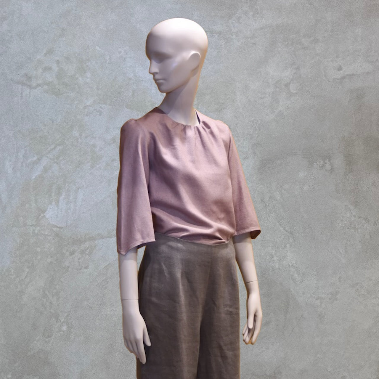 Silk Separates. A Gathered Neck, Puff Sleeve Silk Blouse. Made in Silk Matka, it is light pink with elbow-length sleeves, and paired with high-waisted wide-leg pants. Handmade in Britain.