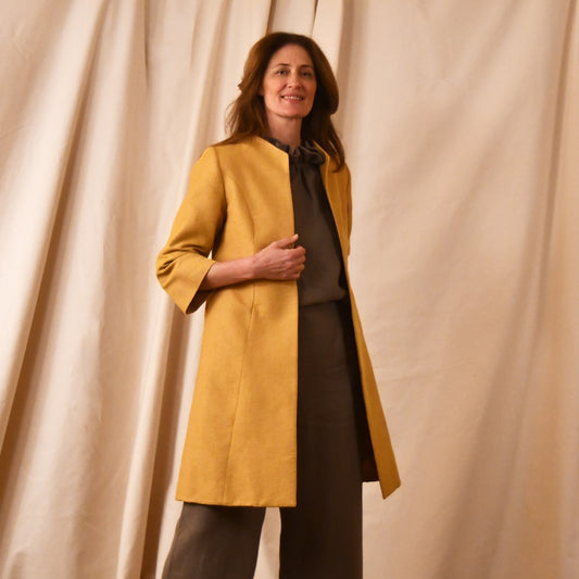 Bespoke Trapeze Swing Coat in Golden Yellow Brocade. Spring Summer MidLength Swing Coat with slight vintage feel and flattering seaming details to front and rear. Shown over contrast linen pant suit.