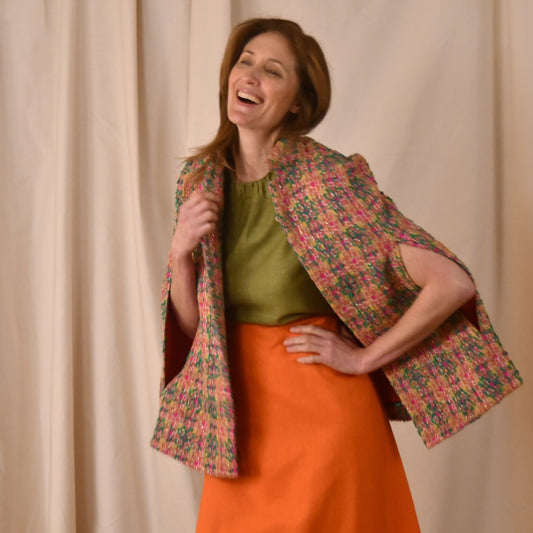 The Clayton Cape in Multicoloured Linton Tweeds Bouclé. A shorter length, easy to wear cape for dressing up or down, mid-season and summer wear. Handmade in Britain. Side View.