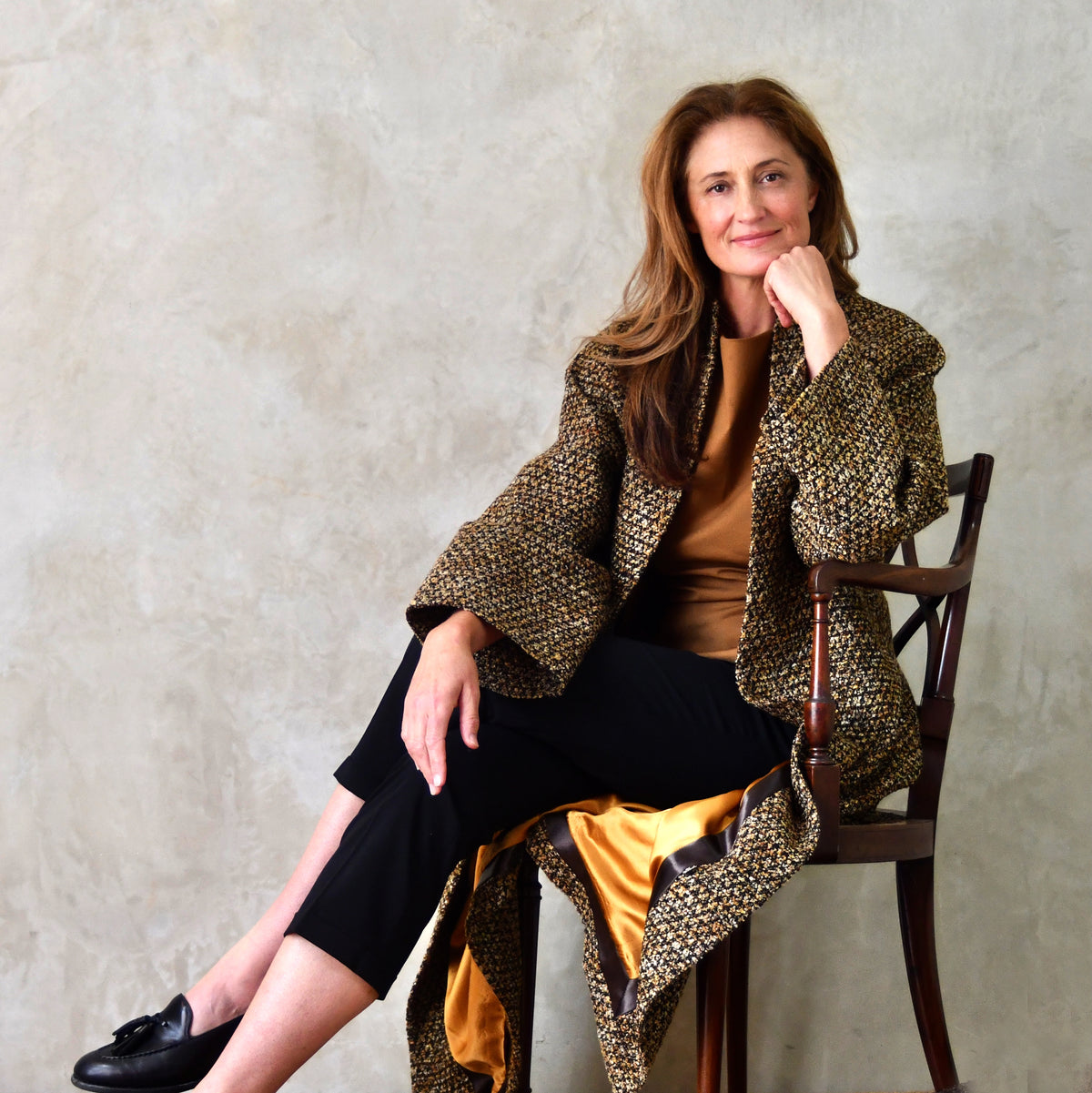 Longer Length Cocoon Coat in Golden Linton Tweeds Boucle. A dramatic, but incredibly wearable cocoon coat in a truly splendid boucle that will carry you well through Autumn and Spring. Handmade in Britain. Seated View.