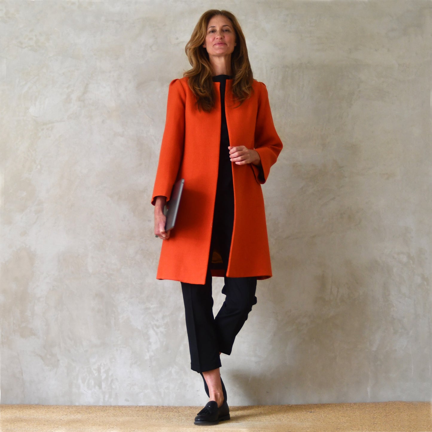 Bespoke Shoulder Detail Trapeze Coat in Burnt Orange Wool Crepe. An elegant alternative to a jacket, our mid length trapeze coat will take you to town, work, country and back. Handmade in Great Britain.