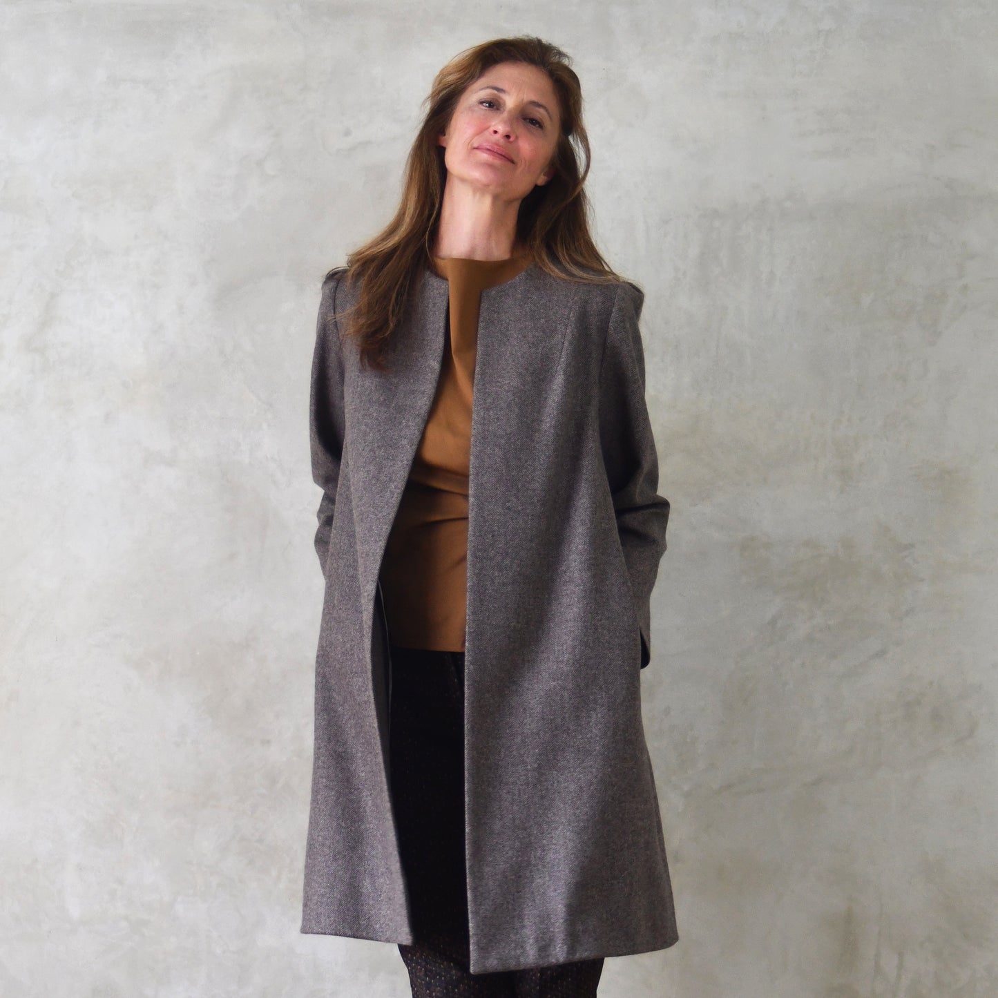 Bespoke Shoulder Detail Trapeze Coat in Fawn Merino Flannel. An elegant alternative to a jacket, our mid length trapeze coat will take you to town and country and back. Close up shot showcasing shoulder detail and bracelet length sleeves. Entirely made in Great Britain.