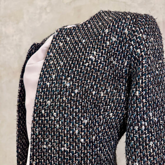 Tailored Hourglass Coat in Metallic Linton Tweeds Boucle. A Longer Length Fitted Bouclé Coat perfect for Evening Wear. An investment piece in the opera coat tradition.
Handmade in Britain.