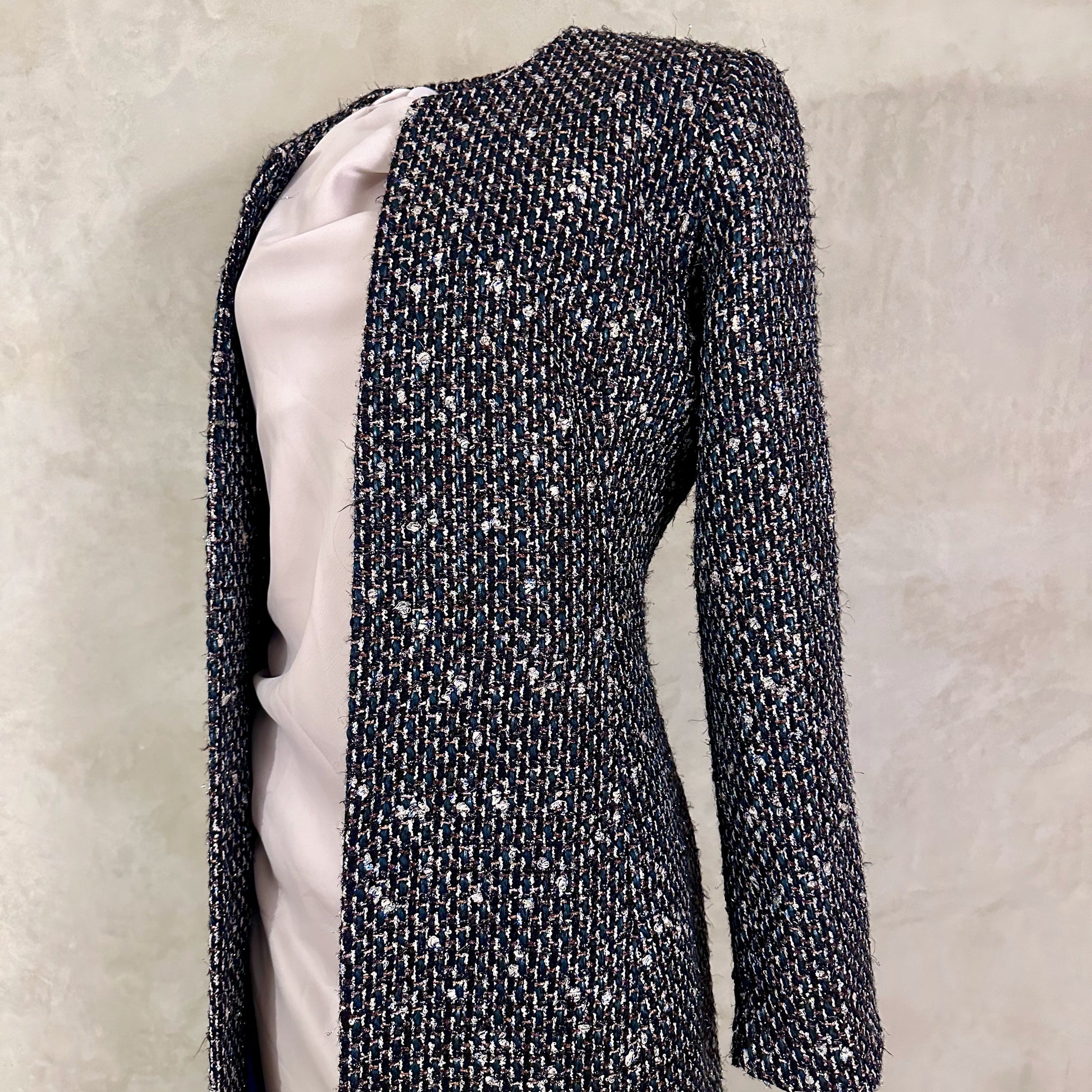 Tailored Hourglass Coat in Metallic Linton Tweeds Boucle. A Longer Length Fitted Bouclé Coat perfect for Evening Wear. An investment piece in the opera coat tradition.
Handmade in Britain.