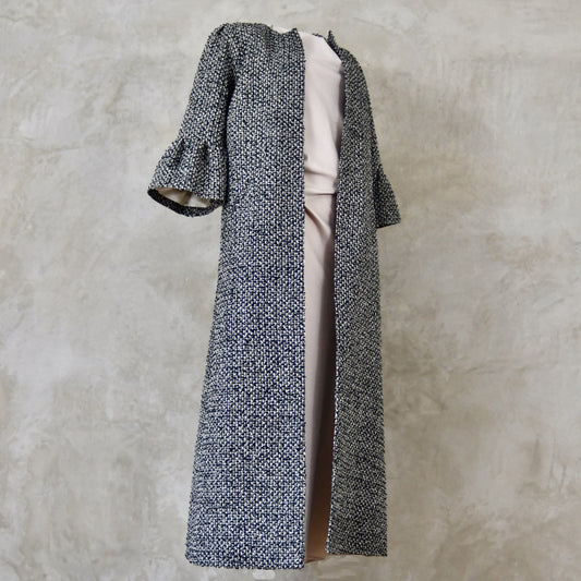 A Longer length Bell Sleeve A-Line Coat in Black and OffWhite Linton Tweeds Boucle
This is an elegant longer length A-Line coat in a patterned boucle from Carlisle. With a magnificent drape and delicate sleeve and shoulder detailing, this coat will take you everywhere. Handmade in Britain.