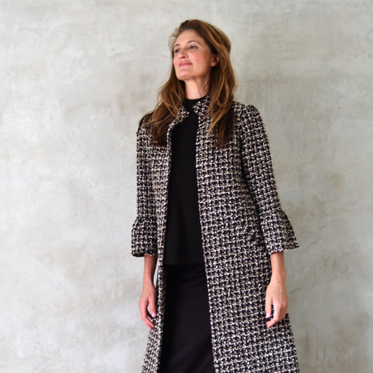 Bespoke Bell Sleeve A-Line Coat in Check Linton Tweeds Boucle. Longer length ivory check boucle coat with frill cuff detail on sleeve – the perfect coat for evening wear and smart occasions. Cut, Made and Finished by Hand in Britain. Close up.