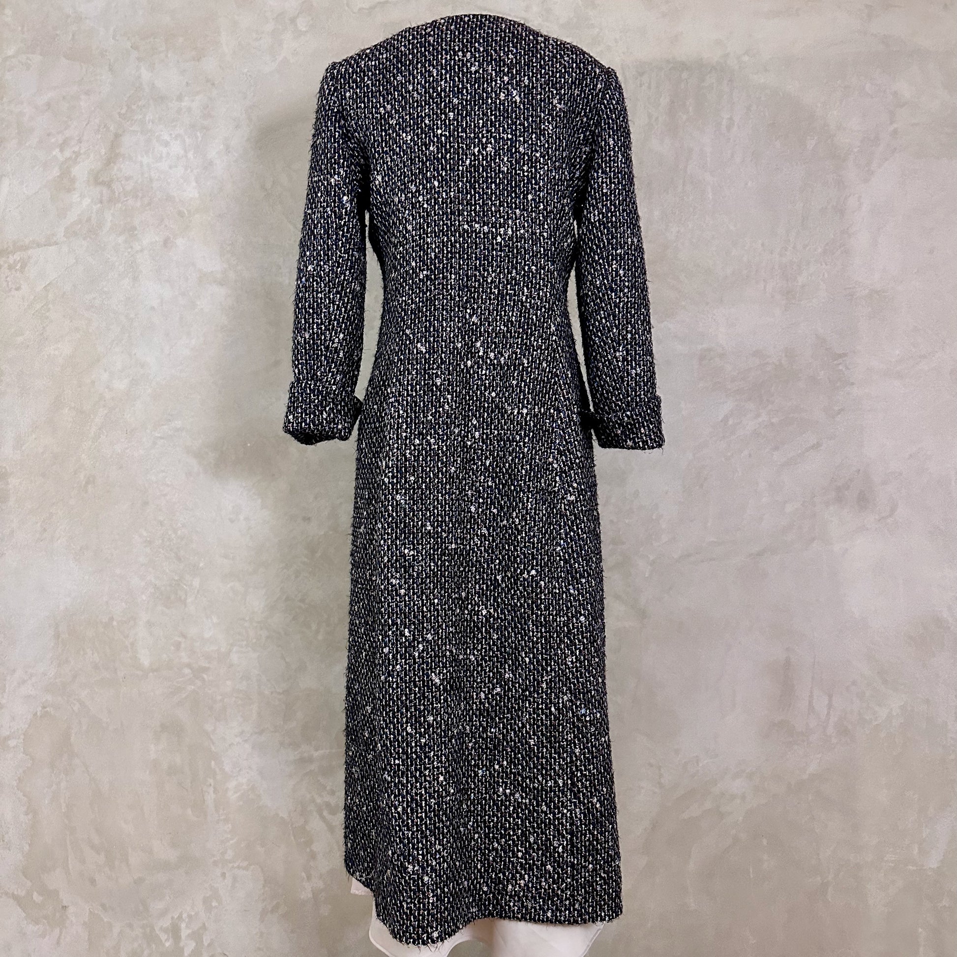 Tailored Hourglass Coat in Metallic Linton Tweeds Boucle. A Longer Length Fitted Bouclé Coat perfect for Evening Wear. An investment piece in the opera coat tradition.
Handmade in Britain. Rear View.