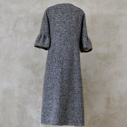 A Longer length Bell Sleeve A-Line Coat in Black and OffWhite Linton Tweeds Boucle
This is an elegant longer length A-Line coat in a patterned boucle from Carlisle. With a magnificent drape and delicate sleeve and shoulder detailing, this coat will take you everywhere. Handmade in Britain. Back View.