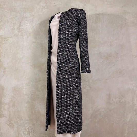 Tailored Hourglass Coat in Metallic Linton Tweeds Boucle. A Longer Length Fitted Bouclé Coat perfect for Evening Wear. An investment piece in the opera coat tradition.
Handmade in Britain.