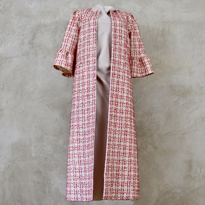 Bell Sleeve A-Line Coat in Pink Patterned Linton Tweeds Boucle. A pretty, longer length A-line coat in a pink, cream and gold check pattern for smart spring and summer occasions. Entirely made in Great Britain. Front View.