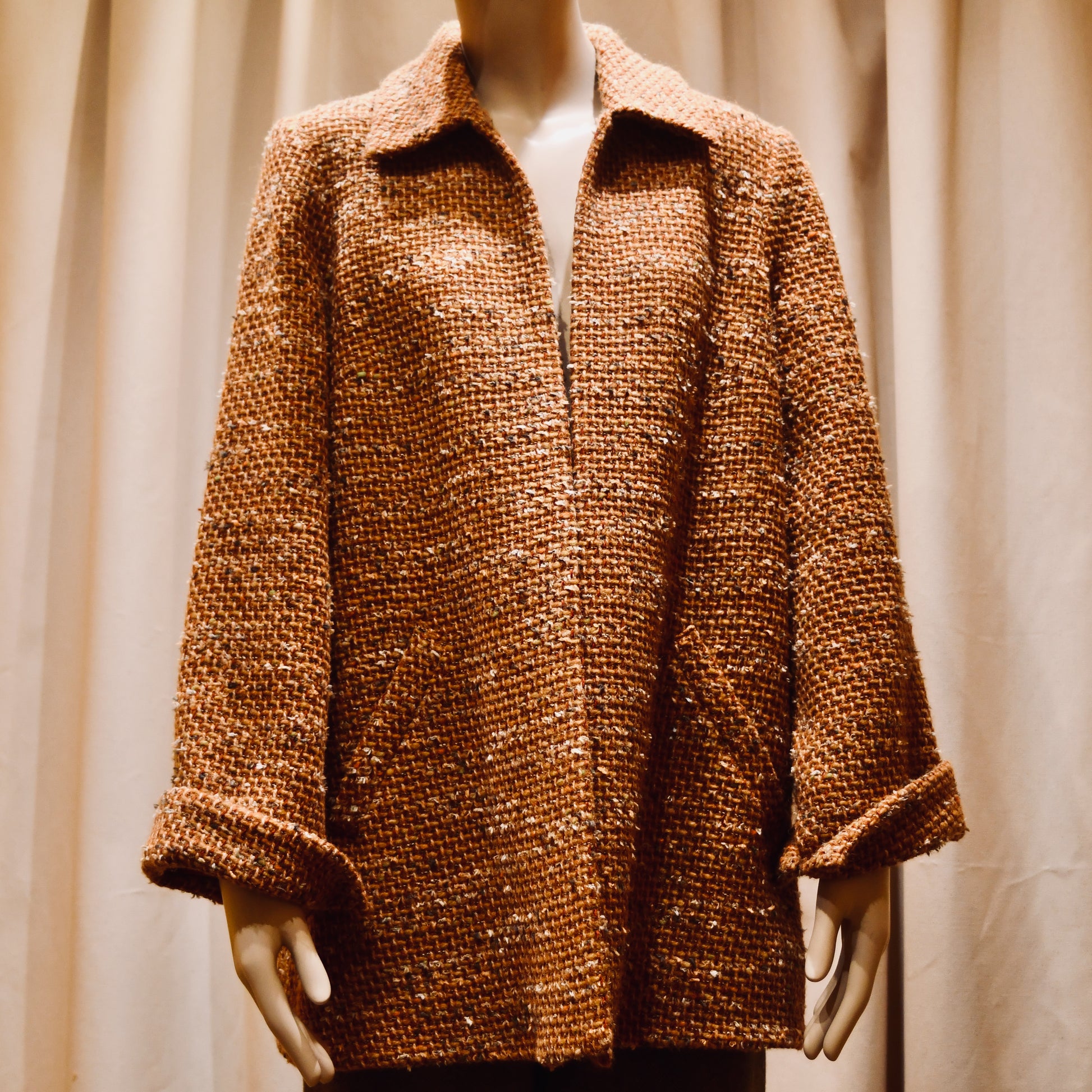 Tailored Swing Jacket in Burnt Orange Wool Mix Bouclé from Linton Tweeds. A women’s long-sleeve, collared coat with slanted front pockets. Sophisticated and easy. Handmade in Britain.