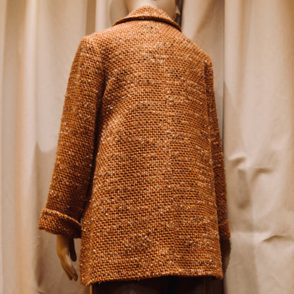 Tailored Swing Jacket in Burnt Orange Wool Mix Bouclé from Linton Tweeds. This bespoke jacket has rolled cuffs and a textured finish. Viewed from the back. Handmade in Britain.
