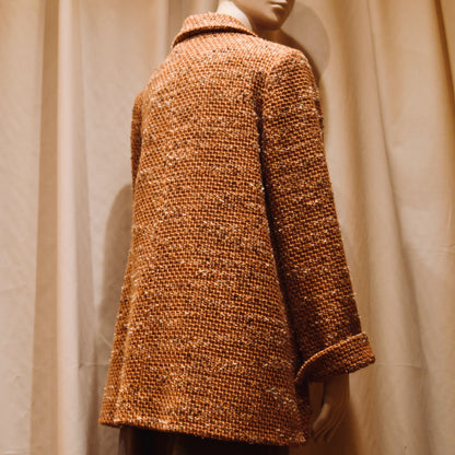 Swing Jacket in Burnt Orange Wool Mix Bouclé from Linton Tweeds. Featuring a collar and turn up sleeve cuffs. Handmade in Britain. Turned View.