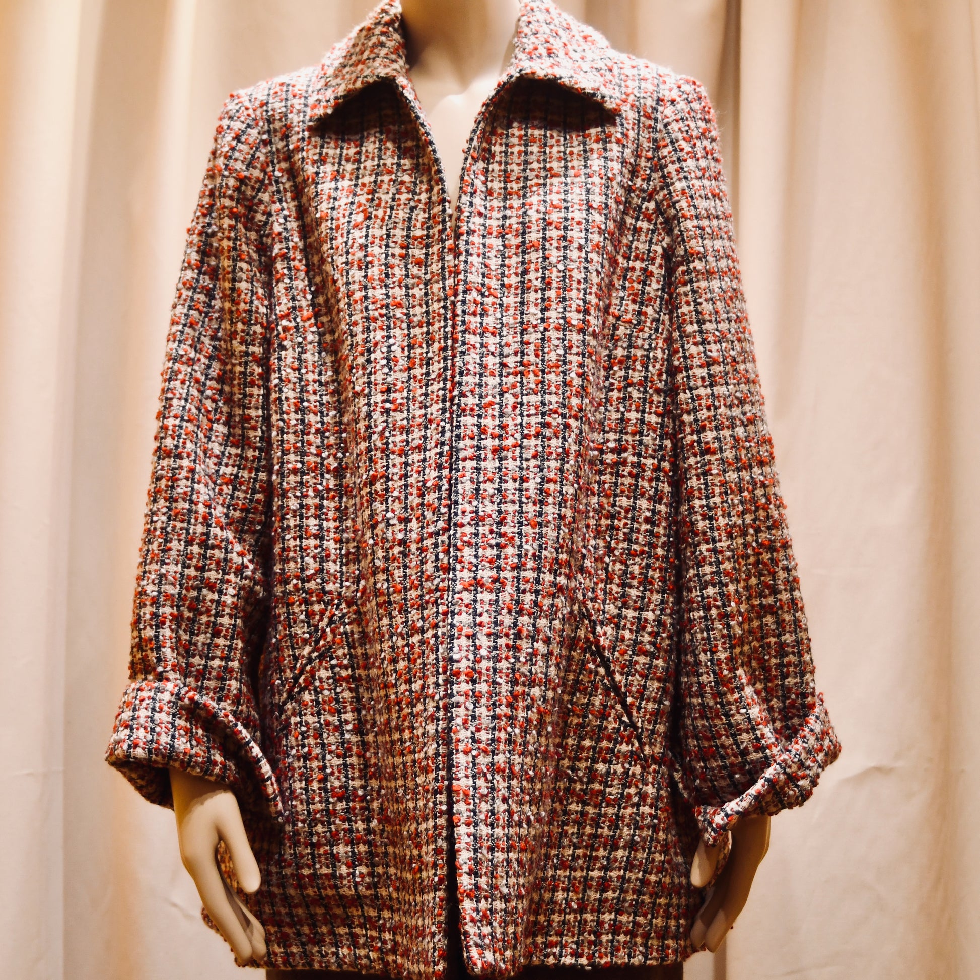Tailored Swing Jacket in in Red, Ecru and Navy Wool Bouclé from Linton Tweeds. This bespoke jacket has rolled cuffs, a textured finish and a flared silhouette. Shown from front. Handmade in Britain.