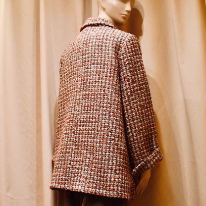 A Swing Trapeze Jacket in Red, Ecru and Navy Wool Mix Bouclé, from Linton Tweeds. Shown from the back.   featuring a collar, textured finish, and multicolored design, Handmade in Britain.
