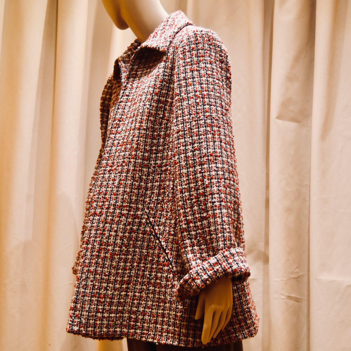 Trapeze Swing Jacket in red, ecru, and navy Wool Bouclé from Linton Tweeds. With long sleeves and a collar,  it is shown viewed from the side. Handmade in Britain.