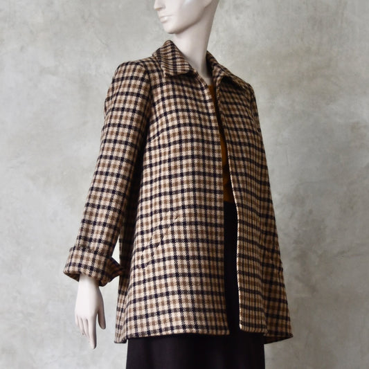 Side Angled view of Swing jacket in pure merino wool. An easy to wear mid length jacket with pockets and a generous collar in Fox Brothers gunclub check flannel. A generous pure merino flannel this is the softest fabric you will touch and will last for eons. Handmade in London. Sizes 6 to 20 and bespoke sizing available.