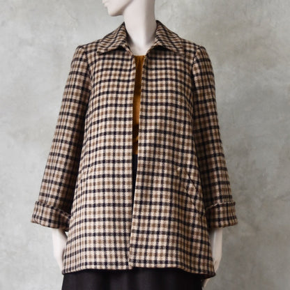 Swing jacket in pure merino wool. An easy to wear mid length jacket with pockets and a generous collar in Fox Brothers gunclub check flannel. A generous pure merino flannel this is the softest fabric you will touch and will last for eons. Handmade in London. Sizes 6 to 20 and bespoke sizing available.