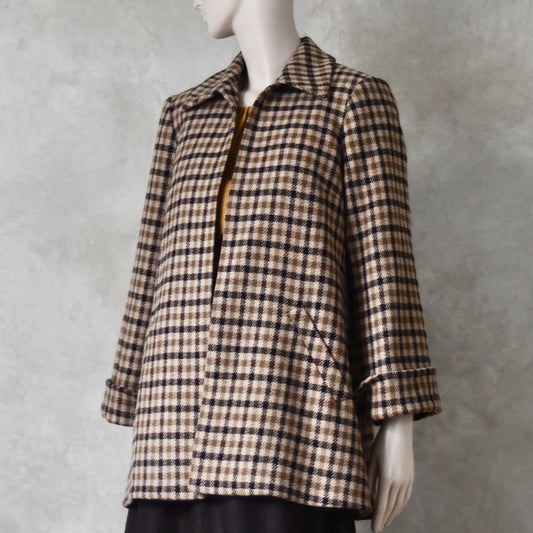 Angled view of Swing jacket in pure merino wool. An easy to wear mid length jacket with pockets and a generous collar in Fox Brothers gunclub check flannel. A generous pure merino flannel this is the softest fabric you will touch and will last for eons. Handmade in London. Sizes 6 to 20 and bespoke sizing available.