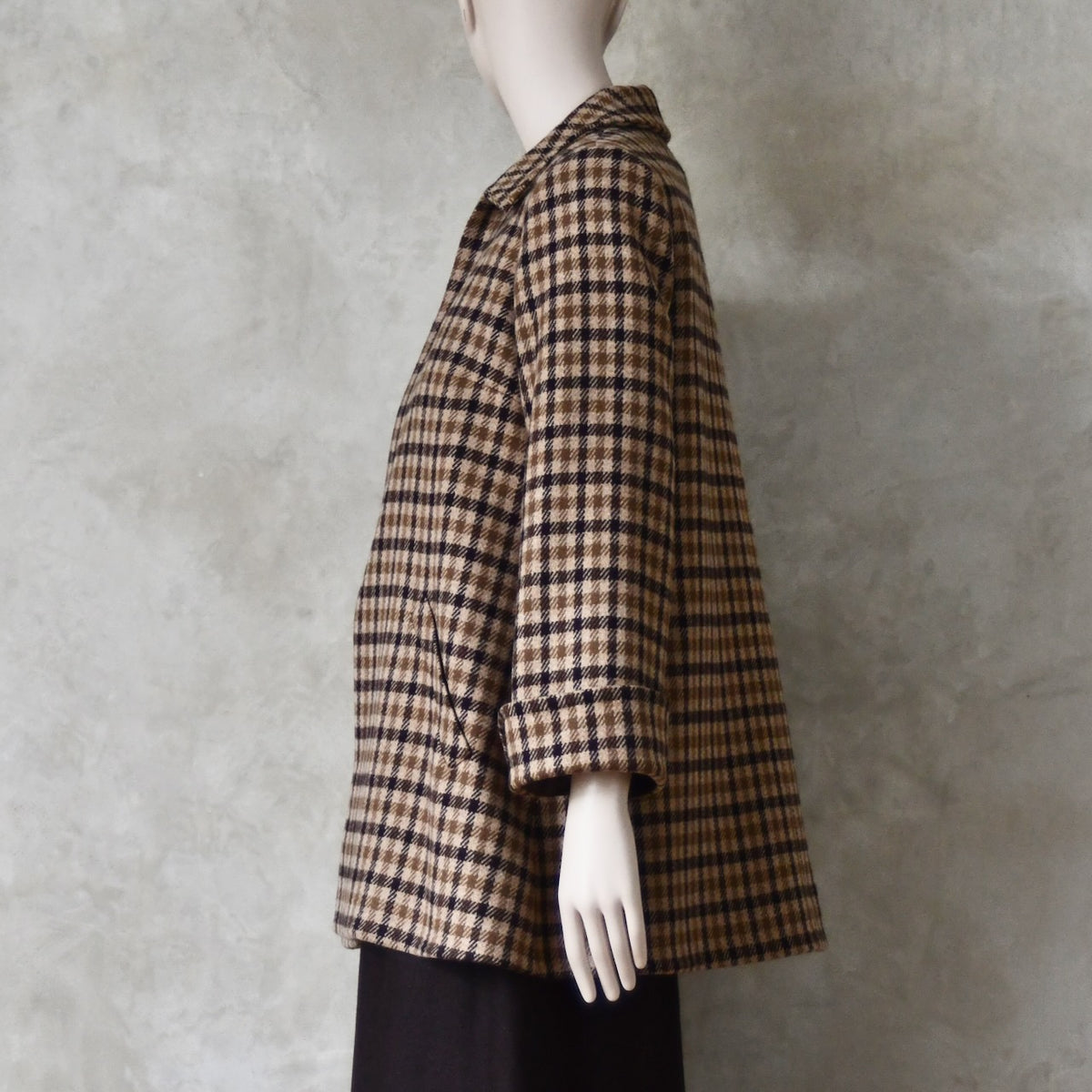 Side view of Swing jacket in pure merino wool. An easy to wear mid length jacket with pockets and a generous collar in Fox Brothers gunclub check flannel. A generous pure merino flannel this is the softest fabric you will touch and will last for eons. Handmade in London. Sizes 6 to 20 and bespoke sizing available.