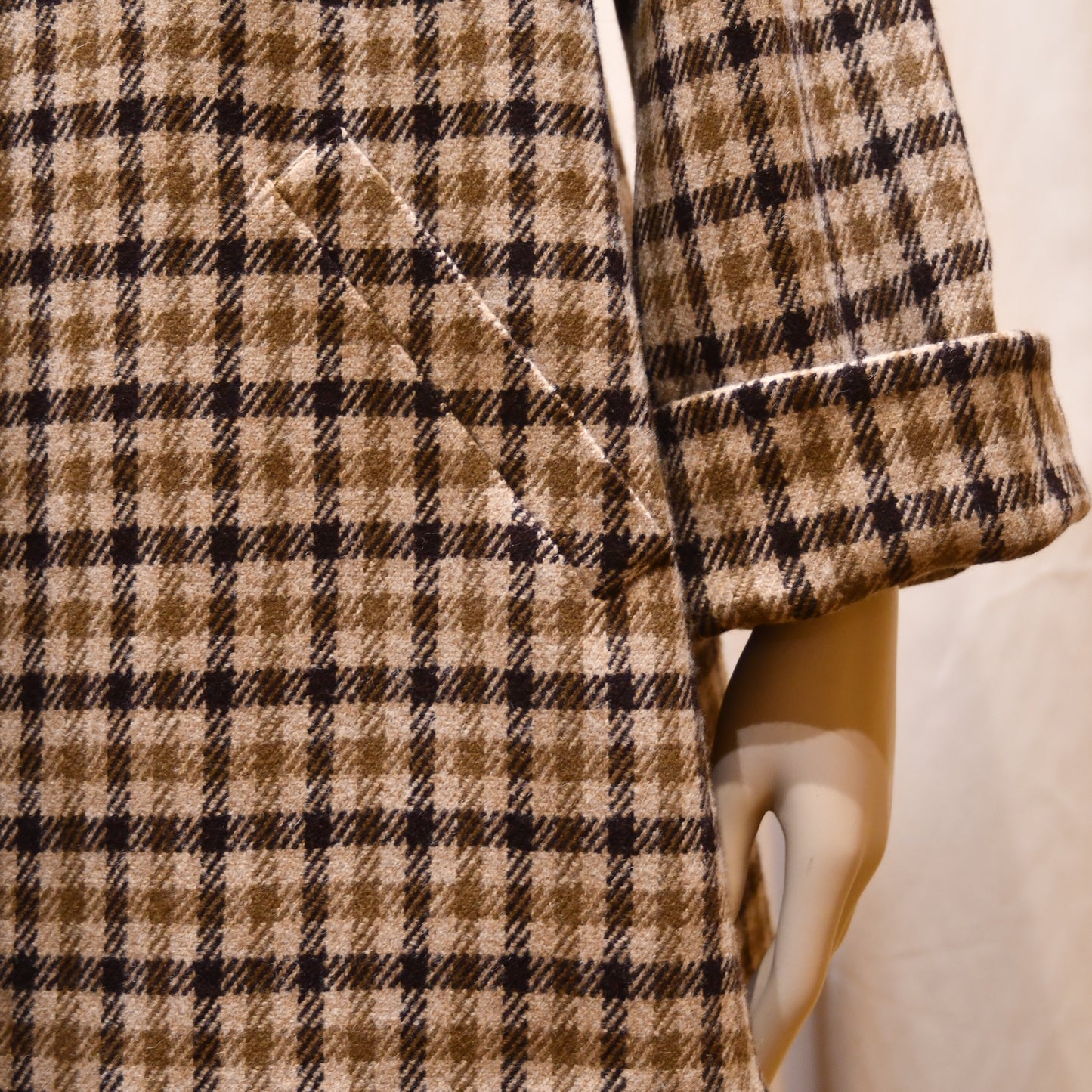 Swing Jacket in Fox Flannel Gunclub Check, featuring brown and creaam checks with long sleeves. Handmade in Britain. Close-up of slanted pocket, and cuffed sleeve.