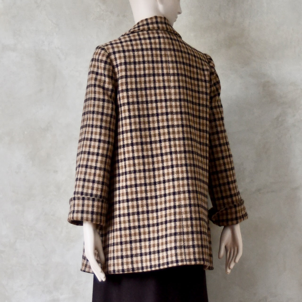 Rear Angled view of Swing jacket in pure merino wool. An easy to wear mid length jacket with pockets and a generous collar in Fox Brothers gunclub check flannel. A generous pure merino flannel this is the softest fabric you will touch and will last for eons. Handmade in London. Sizes 6 to 20 and bespoke sizing available.