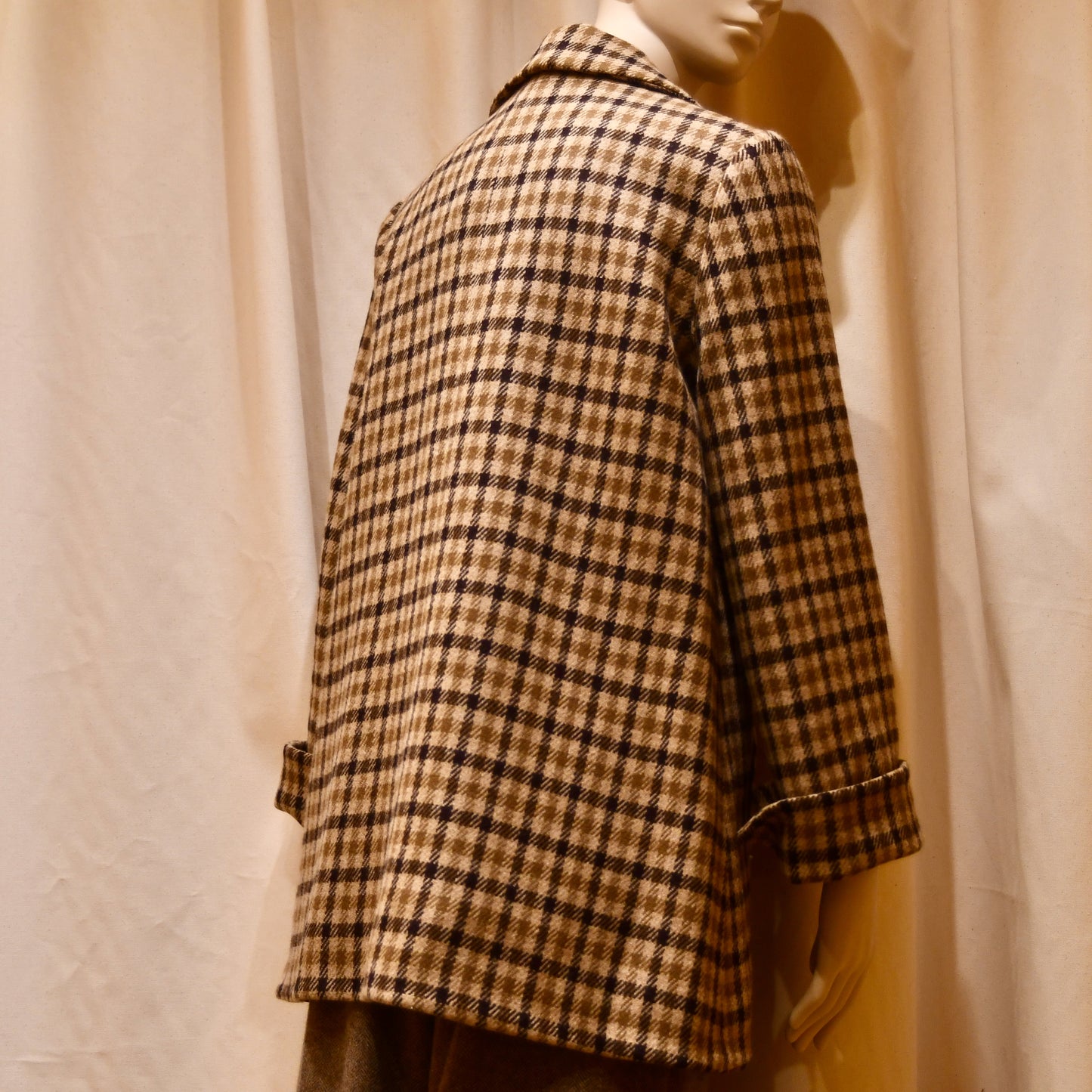 Swing Jacket in Fox Flannel Gunclub Check, featuring brown and cream checks with long sleeves. Handmade in Britain. Photographed from behind, the image highlights the jacket’s back.