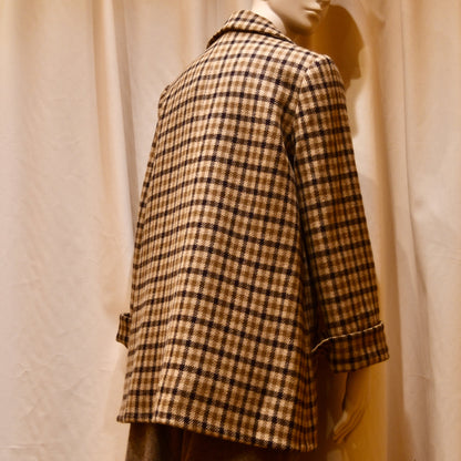 Swing Jacket in Fox Flannel Gunclub Check, featuring brown and cream checks with long sleeves. Handmade in Britain. Photographed from behind, the image highlights the jacket’s back.