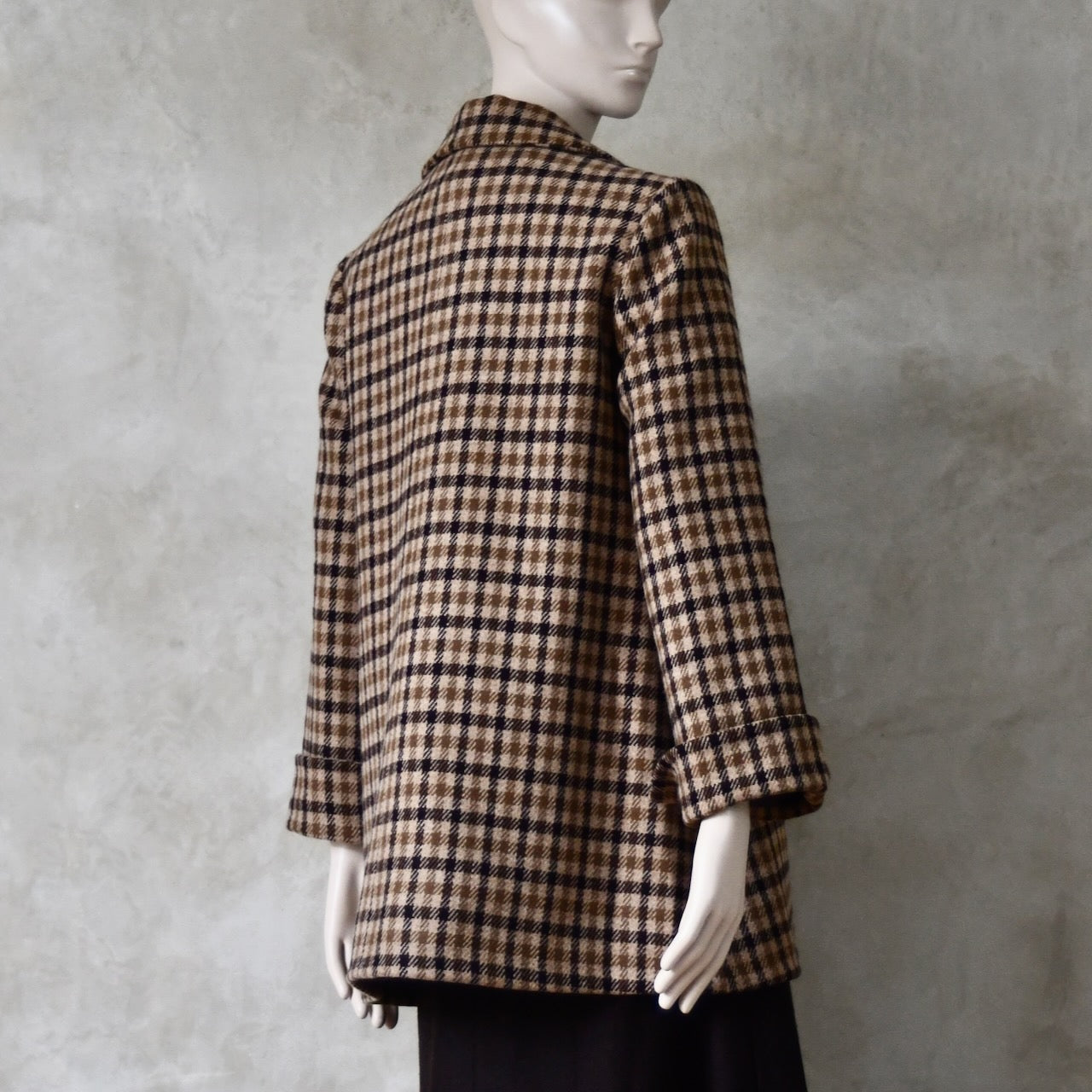 Rear view of Swing jacket in pure merino wool. An easy to wear mid length jacket with pockets and a generous collar in Fox Brothers gunclub check flannel. A generous pure merino flannel this is the softest fabric you will touch and will last for eons. Handmade in London. Sizes 6 to 20 and bespoke sizing available.