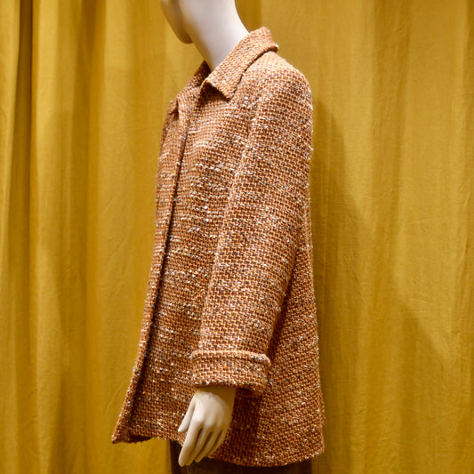 Bespoke Trapeze Swing Jacket in Burnt Orange Wool Mix Bouclé from Linton Tweeds, featuring textured fabric and a side pocket. Side View. Handmade in Britain.