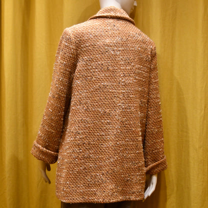 A Swing Trapeze Jacket in Burnt Orange Wool Mix Bouclé, from Linton Tweeds. Shown from the back. Handmade in Britain.