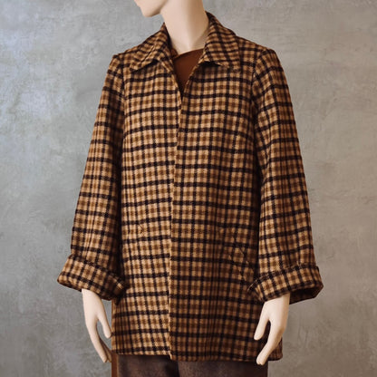 Bespoke Tailored Swing Jacket in Fox Flannel Brown Gunclub Check. A women’s long-sleeve, collared jacket with slanted front pockets. Sophisticated and easy, the jacket is shown from the front. Handmade in Britain.