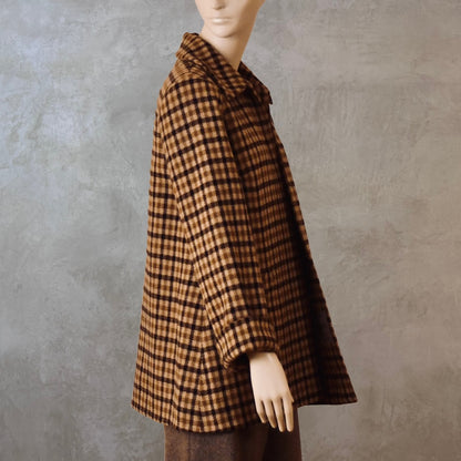 Bespoke Tailored Swing Jacket in Fox Flannel Brown Gunclub Check. A women’s long-sleeve, collared jacket with slanted front pockets. Sophisticated and easy, the jacket is shown from the side. Handmade in Britain.
