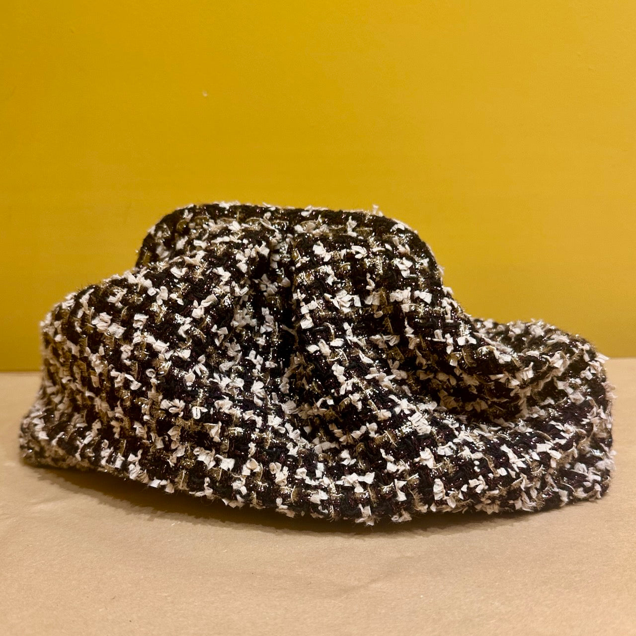 A clutch bag, made by hand in Abergavenny from EdNerat cut offs. In a delicate Linton Tweeds bouclé, this will coordinate  perfect ly with its matching coat or cape.