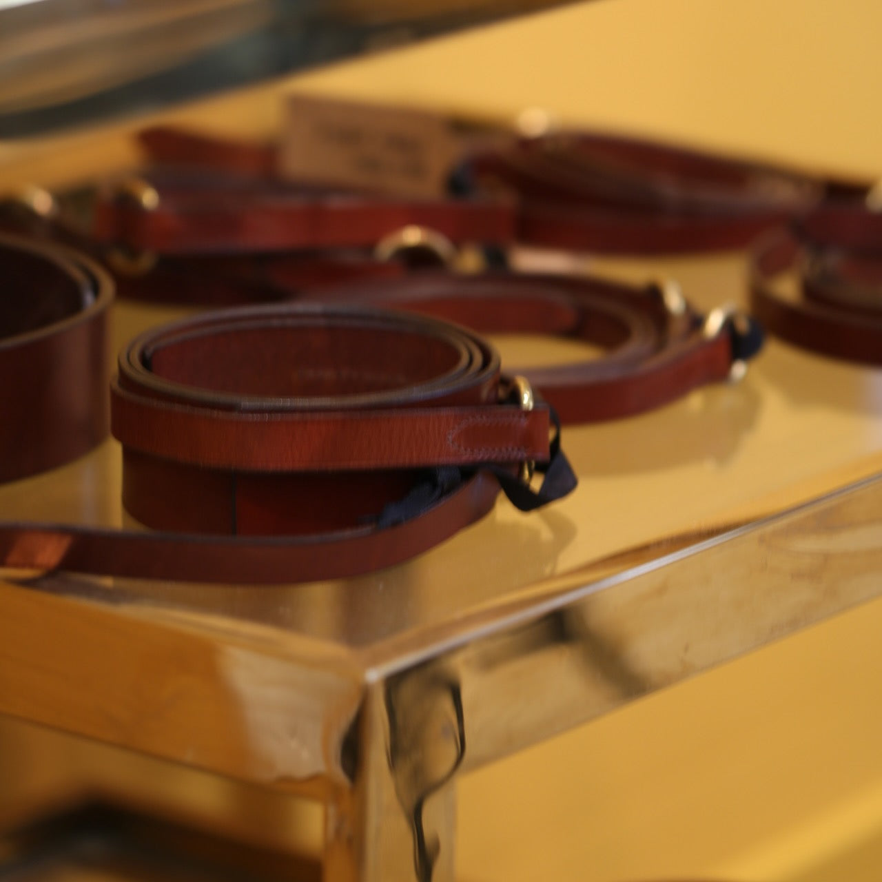 Several EDNERAT Hazel Ring Wrap Belts 68cm in brown British saddle leather with solid brass fittings. Handmade in Britain.