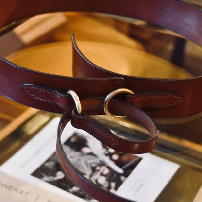 A close-up of the EDNERAT Hazel Ring Wrap Belt - 68cm, made from British saddle leather with solid brass fittings. Handmade in Britain.