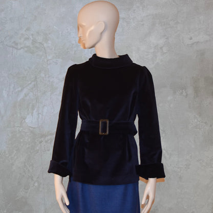 A Tailored Top in Navy Velvet—featuring long sleeves, a high rolled collar, and matching belt—paired with a blue skirt. Ideal for winter evenings. Handmade in Britain.