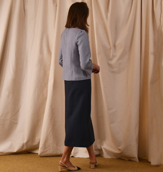 A Tailored Boat Neck Blouse in Pale Blue Silk Matka with a contrasting blue linen skirt. A refined ensemble defined by elegant lines. Handmade in Britain. 