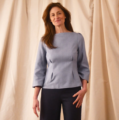 A Tailored Boat Neck Blouse in Pale Blue Silk Matka with contrasting trousers. A refined ensemble defined by elegant lines. Handmade in Britain. 